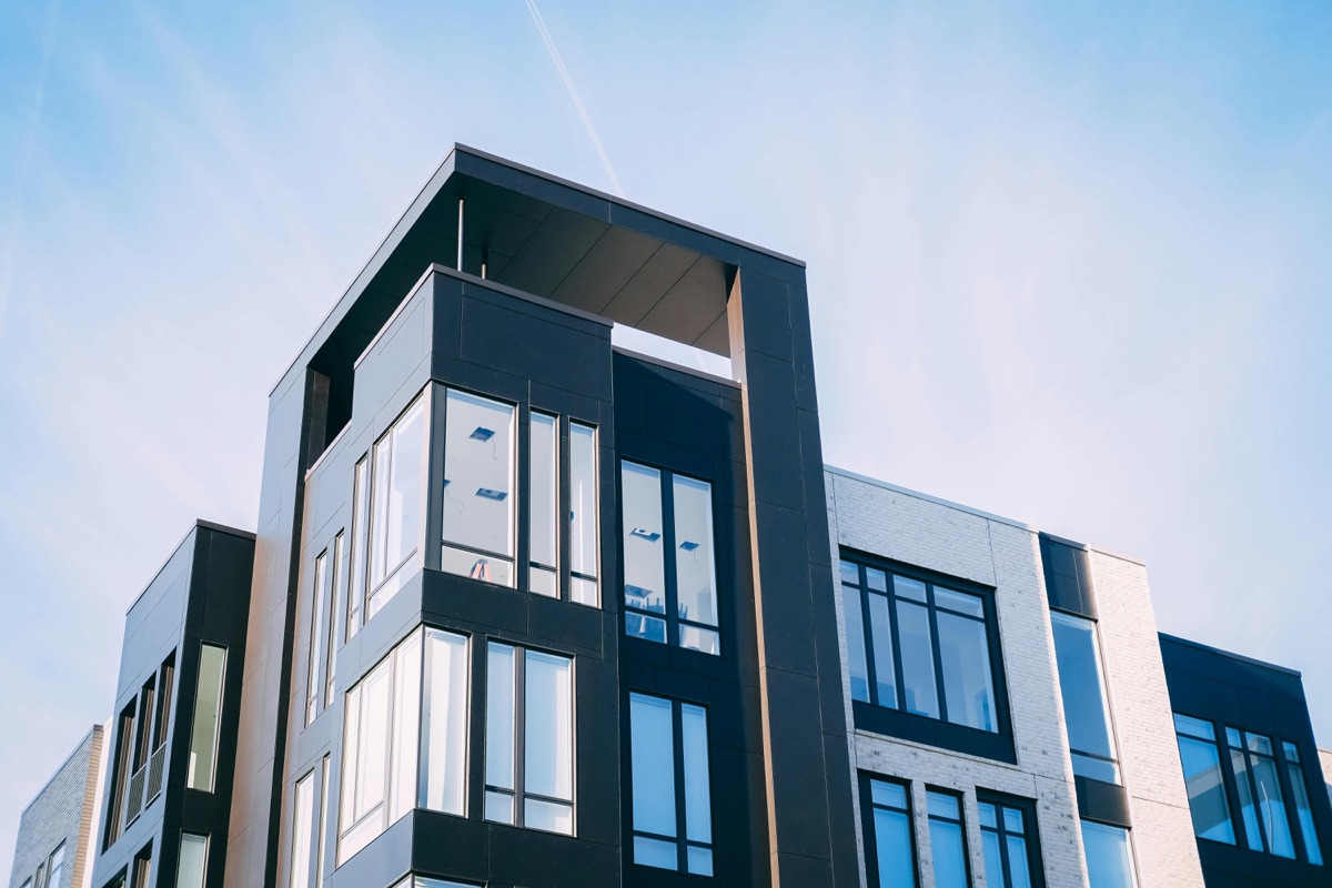 Modern residential apartment building exterior representing the choice between buying and renting property in Delhi