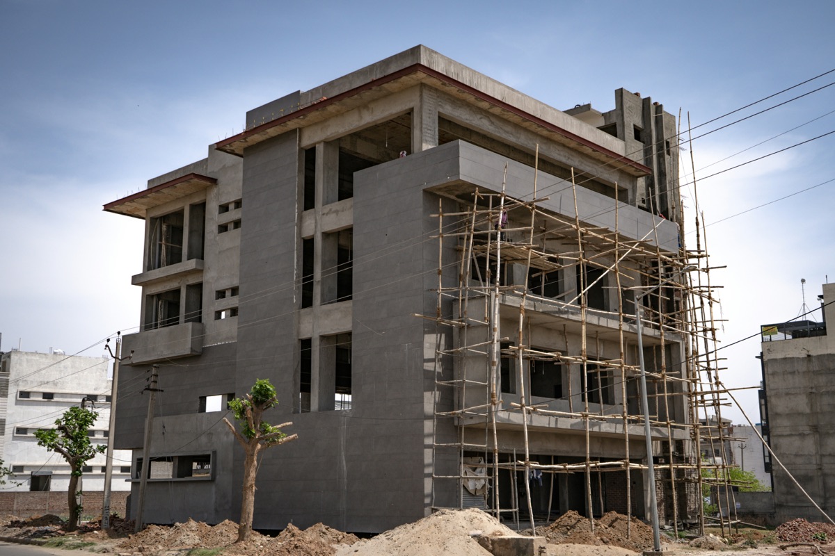 Independent builder floor house under construction on a residential plot in Delhi, relevant for NRI buyers