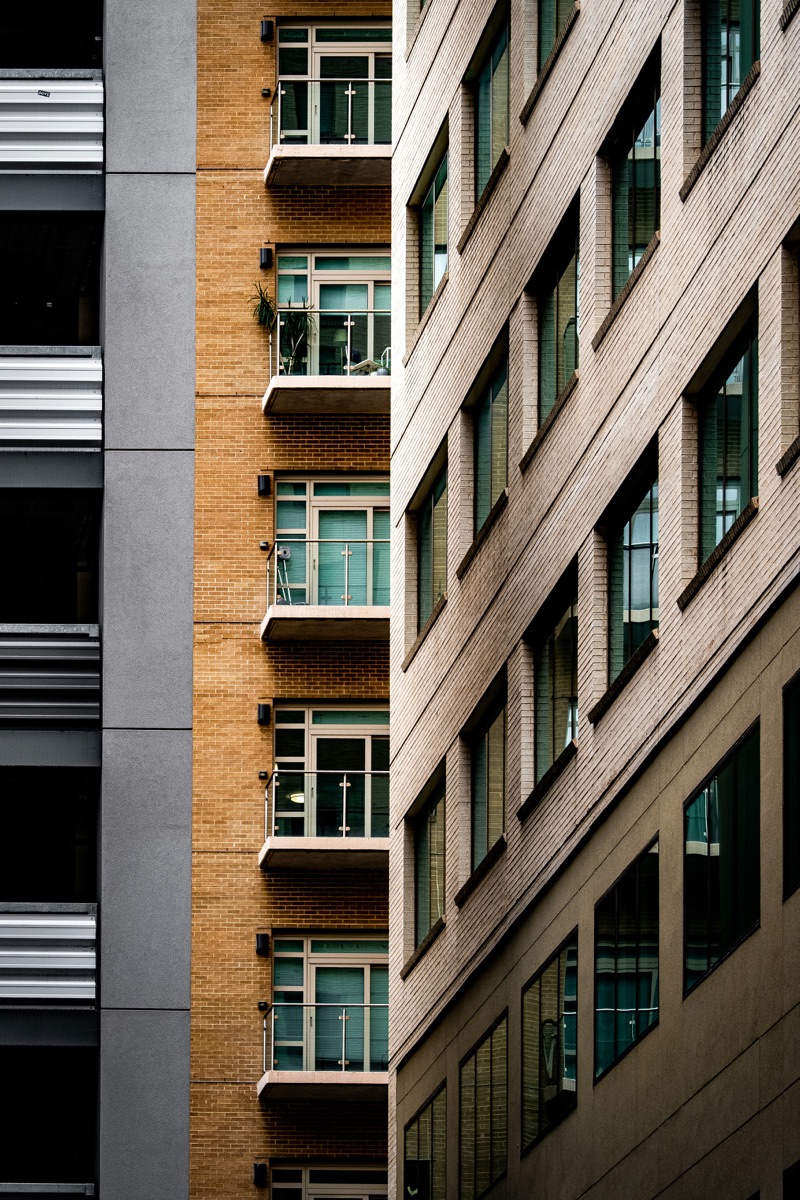 Modern commercial office building alongside residential apartments representing residential vs commercial property investment in Delhi